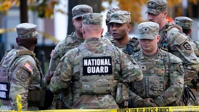 National Guard members stand together behind yellow tape, after two National Guard members were shot near the White House. (REUTERS)