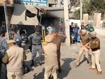 A video grab of Punjab Police personnel rushing to the rescue of Dhuri station house officer Jasvir Singh, who suffered burns after his uniform caught fire during the clash with protesters, outside the Sangrur bus stand on Friday morning. Some of the protesters were carrying bottles of petrol while sitting atop buses.