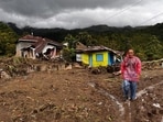 People walk past damaged houses at a village affected by flood in Malalak, West Sumatra, Indonesia. People walk past damaged houses at a village affected by flood in Malalak, West Sumatra, Indonesia.