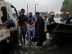 Members of the Sri Lankan Army along with villagers help a person in a wheelchair to a safe location from flooded streets following heavy rainfall in Wellampitiya, Sri Lanka, November 28, 2025.
