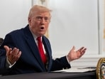 President Donald Trump speaks to reporters after speaking to troops via video from his Mar-a-Lago estate on Thanksgiving