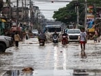 People commute through a flooded area in Hat Yai district, Songkhla province, Thailand, November 28, 2025. 