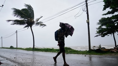 A man walks under a heavy downpour in Colombo, Sri Lanka, Friday, Nov. 28, 2025. (AP) A man walks under a heavy downpour in Colombo, Sri Lanka, Friday, Nov. 28, 2025. (AP)