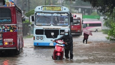 People and vehicles wade through a waterlogged street following heavy rainfall in Kelaniya, Sri Lanka, November 28, 2025. (REUTERS)