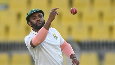 Temba Bavuma tosses the ball during the fourth day of the second Test cricket match between India and South Africa in Guwahati on November 25 (AFP)