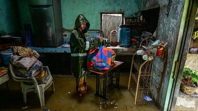 A man packs his belongings as he stands inside his house partially submerged in floodwaters after heavy rainfall in Kaduwela on the outskirts of Colombo on November 28, 2025. (AFP) A man packs his belongings as he stands inside his house partially submerged in floodwaters after heavy rainfall in Kaduwela on the outskirts of Colombo on November 28, 2025. (AFP)