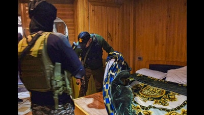 Security personnel conduct a search operation at a hotel, in Srinagar, on Friday. (PTI)