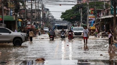 People commute through a flooded area in Hat Yai district, Songkhla province, Thailand, November 28, 2025. (REUTERS)