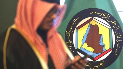 A man looks at his mobile phone in front of the flag of the Gulf Cooperation Council, GCC, in Kuwait City. (AP) A man looks at his mobile phone in front of the flag of the Gulf Cooperation Council, GCC, in Kuwait City. (AP)