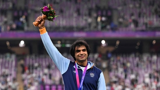 Neeraj Chopra celebrates on the podium during the medal ceremony for the men's javelin throw final athletics event during the 2022 Asian Games. (AFP)