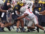 Jordan Marshall #23 of the Michigan Wolverines is tackled by Sonny Styles #0 of the Ohio State Buckeyes Jordan Marshall #23 of the Michigan Wolverines is tackled by Sonny Styles #0 of the Ohio State Buckeyes