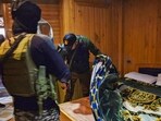 Security personnel conduct a search operation at a hotel, in Srinagar, on Friday. (PTI)