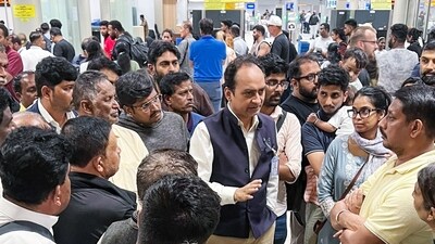 Acting High Commissioner Satyanjal Pandey meets stranded Indian passengers at Bandaranaike International Airport due to Cyclone Ditwah, in Colombo on Saturay. (@IndiainSL X/ANI Photo)
