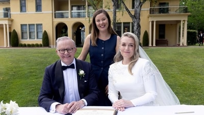 Albanese and his new wife Jodie Haydon sign the marriage certificate with celebrant Bree during their wedding ceremony in Canberra on November 29, 2025. According to an official statement, the couple exchanged vows before about 60 guests, including actor Russell Crowe and several cabinet ministers. Media were not informed in advance of the event. “We are absolutely delighted to share our love and commitment to spending our future lives together, in front of our family and closest friends,” the statement said. (AFP) Albanese and his new wife Jodie Haydon sign the marriage certificate with celebrant Bree during their wedding ceremony in Canberra on November 29, 2025. According to an official statement, the couple exchanged vows before about 60 guests, including actor Russell Crowe and several cabinet ministers. Media were not informed in advance of the event. “We are absolutely delighted to share our love and commitment to spending our future lives together, in front of our family and closest friends,” the statement said. (AFP)