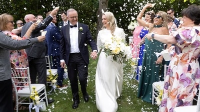 Anthony Albanese and Jodie Haydon walk down the aisle after getting married in Canberra.&nbsp; (via REUTERS)