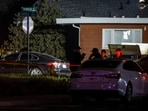 Investigators with the San Joaquin Sheriff's Department stand near the site of a deadly shooting at a home in Stockton, California, on Sunday, November 30, 2025. Investigators with the San Joaquin Sheriff's Department stand near the site of a deadly shooting at a home in Stockton, California, on Sunday, November 30, 2025.