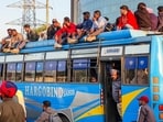 Commuters board a private bus, a day after a strike by PRTC contractual workers over detainment of their leaders by police, at a bus stand, in Patiala, on Saturday. (PTI) Commuters board a private bus, a day after a strike by PRTC contractual workers over detainment of their leaders by police, at a bus stand, in Patiala, on Saturday. (PTI)