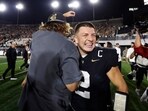 Diego Pavia #2 of the Vanderbilt Commodores and comedian Theo Vonn celebrate after an overtime victory against the Auburn Tigers 