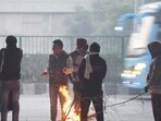 Gurugram, India-December 17, 2023: People stand close to the bonfire on a cold winter morning under the Iffco chowk elevated flyover near foot-over-bridge, in Gurugram, India, on Sunday, 17 December 2023. (Photo by Parveen Kumar/Hindustan Times) Gurugram, India-December 17, 2023: People stand close to the bonfire on a cold winter morning under the Iffco chowk elevated flyover near foot-over-bridge, in Gurugram, India, on Sunday, 17 December 2023. (Photo by Parveen Kumar/Hindustan Times)