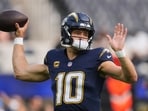 Los Angeles Chargers quarterback Justin Herbert (10) warms up before an NFL football game against the Las Vegas Raiders, Sunday, Nov. 30, 2025, in Inglewood, California. Los Angeles Chargers quarterback Justin Herbert (10) warms up before an NFL football game against the Las Vegas Raiders, Sunday, Nov. 30, 2025, in Inglewood, California.