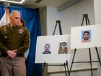 An officer looks towards pictures of two National Guard members who were shot in Washington on November 26, along with a picture of the suspect, Afghan national Rahmanullah Lakanwal.