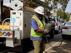 An AT&T worker gathers a wire that contains copper and was retrieved from a cut line in Los Angeles. An AT&T worker gathers a wire that contains copper and was retrieved from a cut line in Los Angeles.