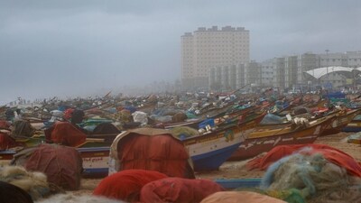 A man stands amidst fishing boats docked on the shore, ahead of Cyclone Ditwah, in Chennai, India, November 30, 2025. (REUTERS)