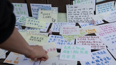 People leave notes with well-wishes for those affected by the deadly fire at the Wang Fuk Court housing complex, in Tai Po, Hong Kong, China, November 30, 2025. (REUTERS)