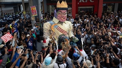 Filipino activists destroy an effigy depicting Philippine President Ferdinand "Bongbong" Marcos Jr and Vice President Sara Duterte during an anti-corruption protest. (REUTERS)