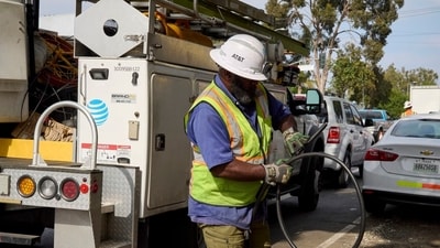 An AT&T worker gathers a wire that contains copper and was retrieved from a cut line in Los Angeles. An AT&T worker gathers a wire that contains copper and was retrieved from a cut line in Los Angeles.