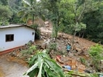 A man salvages goods from debris following a landslide in the aftermath of Cyclone Ditwah in Sarasavigama, Kandy District, Sri Lanka