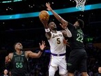 Deandre Ayton of the Los Angeles Lakers attempts a shot between Trey Alexander and Kevon Looney of the New Orleans Pelicans
