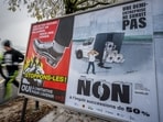 Voting posters in favor and against an initiative to tax the super-rich to help to finance the country's effort against climate change is seen in a street in Geneva, on November 25. Voting posters in favor and against an initiative to tax the super-rich to help to finance the country's effort against climate change is seen in a street in Geneva, on November 25.