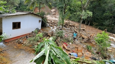 A man salvages goods from debris following a landslide in the aftermath of Cyclone Ditwah in Sarasavigama, Kandy District, Sri Lanka (Reuters)