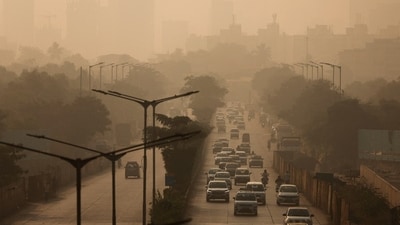 Vehicles move along a road on a smoggy morning, as air pollution persists in Mumbai. (REUTERS)