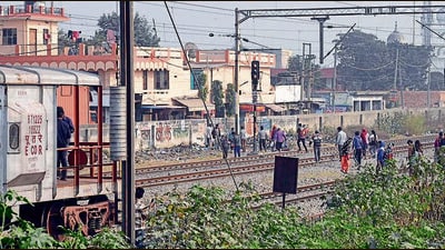 People crossing the tracks to scale the wall erected by the railways. (Gurpreet Singh/HT) People crossing the tracks to scale the wall erected by the railways. (Gurpreet Singh/HT)