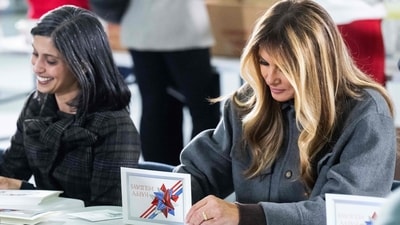 US First Lady Melania Trump (R) and Second Lady Usha Vance write notes to place into a care package for deployed members of the US military during an American Red Cross holiday event with military families at Joint Base Andrews in Maryland, December 1, 2025. (AFP) US First Lady Melania Trump (R) and Second Lady Usha Vance write notes to place into a care package for deployed members of the US military during an American Red Cross holiday event with military families at Joint Base Andrews in Maryland, December 1, 2025. (AFP)