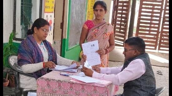 A BLO Kamlesh Kumar Sharma and his assistants at work in Sisauli, Lucknow. (SOURCED)