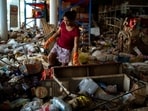 A woman cleans a wholesale store following deadly flooding in Hat Yai district, Songkhla province, Thailand.