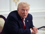 FILE PHOTO: U.S. President Donald Trump speaks with members of the media following a call with military service members, on Thanksgiving, in Palm Beach, Florida, U.S., November 27, 2025. REUTERS/Anna Rose Layden/File Photo