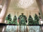 Christmas trees in the Cross Hall of the White House during a media tour of the White House Christmas decorations in Washington, DC, US, on Monday, Dec. 1, 2025. The theme of the 2025 White House Christmas decorations is "Home Is Where The Heart Is." Photographer: Al Drago/Bloomberg Christmas trees in the Cross Hall of the White House during a media tour of the White House Christmas decorations in Washington, DC, US, on Monday, Dec. 1, 2025. The theme of the 2025 White House Christmas decorations is "Home Is Where The Heart Is." Photographer: Al Drago/Bloomberg