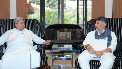 Karnataka CM Siddaramaiah meets his deputy DK Shivakumar on Tuesday morning. Karnataka CM Siddaramaiah meets his deputy DK Shivakumar on Tuesday morning.