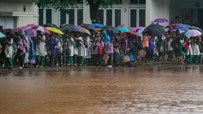 Students walk past the waterlogged portion of their school amid rain due to Cyclone Ditwah, in Chennai, Monday. (PTI Photo/R Senthilkumar) Students walk past the waterlogged portion of their school amid rain due to Cyclone Ditwah, in Chennai, Monday. (PTI Photo/R Senthilkumar)