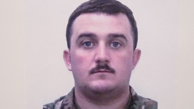 A picture of National Guard member Andrew Wolfe is displayed at a press conference with FBI Director Kash Patel, U.S. Attorney for D.C. Jeanine Pirro and other authorities, after Wolfe and National Guard member Sarah Beckstrom were shot in Washington on November 26, in Washington, D.C., U.S., November 27, 2025. REUTERS/Nathan Howard (REUTERS)