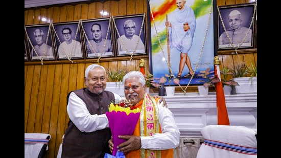 Bihar CM Nitish Kumar greets newly elected assembly speaker Prem Kumar on the second day of Winter session of the State Assembly in Patna on Tuesday. (PTI)