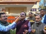 Delhi BJP leaders celebrate with sweets the victory in Municipal Corporation of Delhi on Wednesday. (Sanchit Khanna/HT Photo) Delhi BJP leaders celebrate with sweets the victory in Municipal Corporation of Delhi on Wednesday. (Sanchit Khanna/HT Photo)