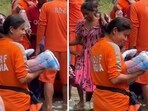 A rescuer holding an infant in Sri Lanka. 