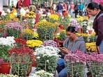 Visitors at Chrysanthemum Show orgainsed by Punjab Agricultural University in Ludhiana on Tuesday. (Gurpreet Singh/HT)