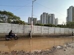Water logging on the Dhanwapur road due to broken sewer manhole near Godrej Summit residential society in Gurugram. (Parveen Kumar/HT PHOTO)