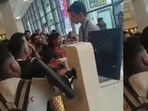 Airline employees appear overwhelmed as they attempt to pacify the crowd. Airline employees appear overwhelmed as they attempt to pacify the crowd.